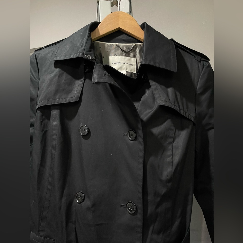 Beautiful woman’s black Banana Republic trenchcoat